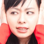 Woman with hands over her ears