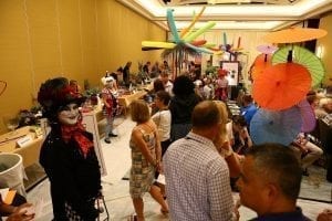 During the “Cirque du Fleur” themed Sylvia Cup Design Competition during SAF Amelia Island 2015, D Damon Samuel, AAF, AIFD, PFCI, NAFD, NMF, of the Bill Doran Company in Omaha, Nebraska, in costume and makeup, welcomed attendees and the general public to watch the contestants in action. See photos from last year’s Sylvia Cup on Flickr.