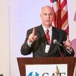 Shawn McBurney SAF" Senior Director of Government Relations speaking at a podium
