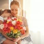 stock image of a mom receiving flowers